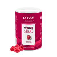 Anona GmbH Complete Shake Himbeer-Joghurt in einem rosa Behälter, mit einem Himbeermotiv auf dem Etikett und mehreren frischen Himbeeren daneben, vor weißem Hintergrund.